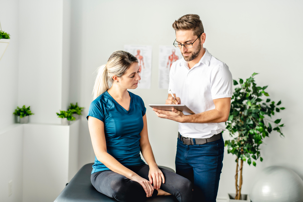 Chiropractor treating patient with medical care and supplements